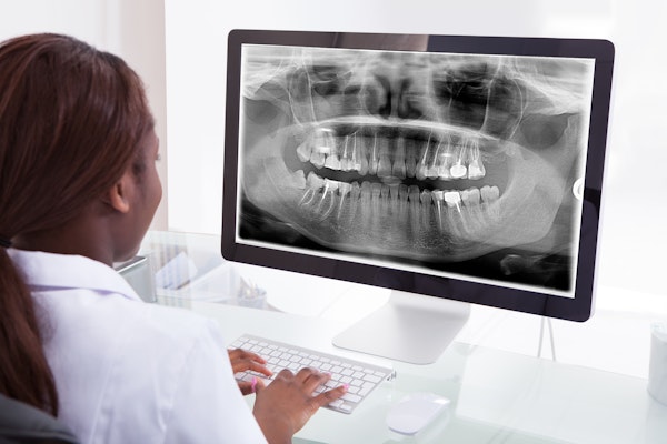 Dentist looking at X-rays