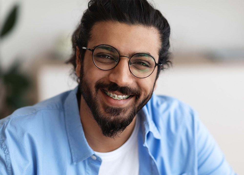 Smiling man with braces