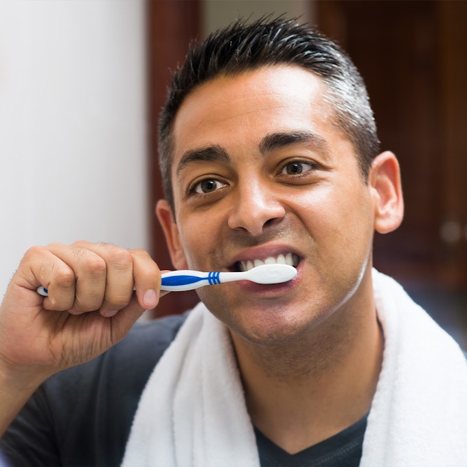 a man brushing his teeth