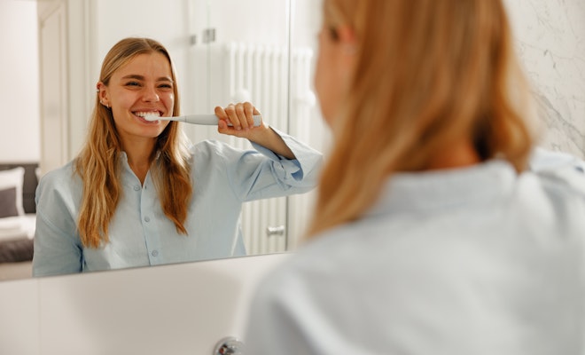 Young woman brushing her teeth