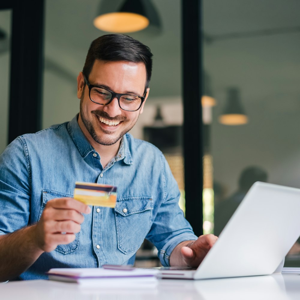 Man holding credit card and smiling