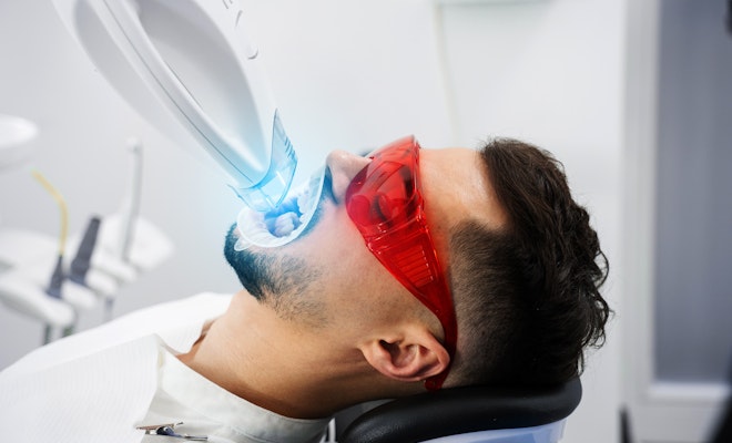 Young man getting his teeth whitened