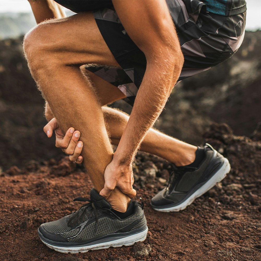 Person clutching ankle