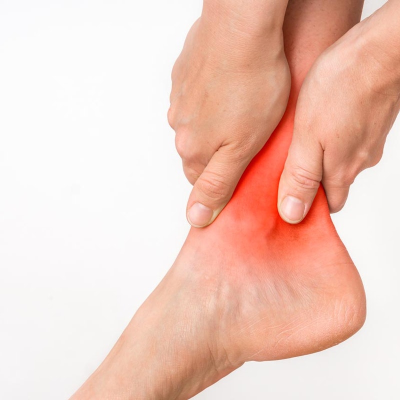 Person holding ankle in pain