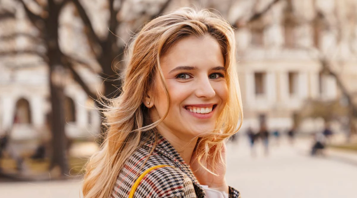 young woman in the city smiling