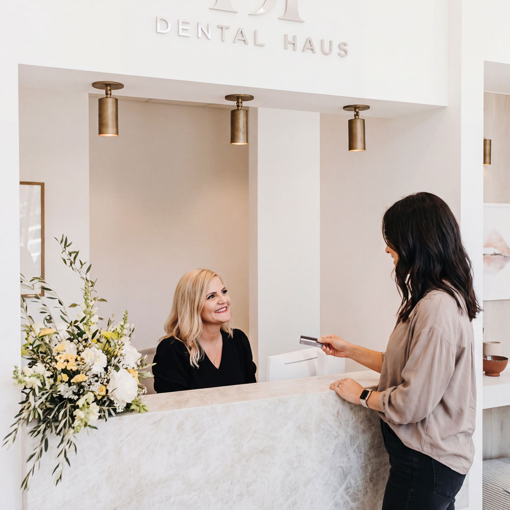 Woman speaking with receptionist at Dental Haus Germantown