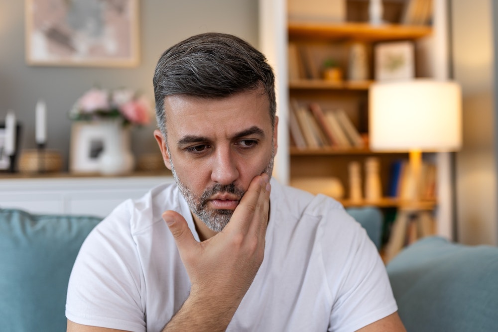 Man touching his face