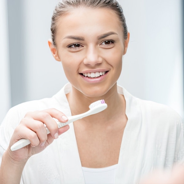 woman brushing teeth