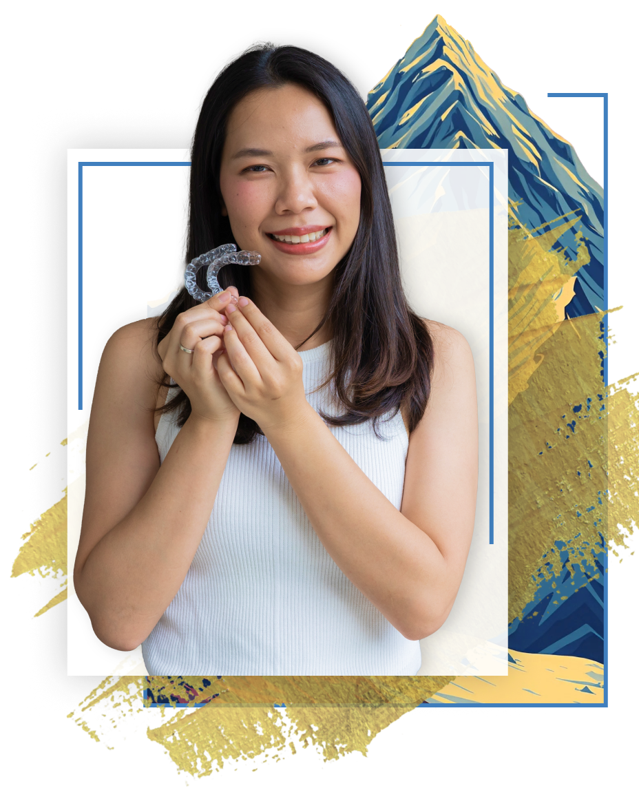 woman holding Invisalign aligners