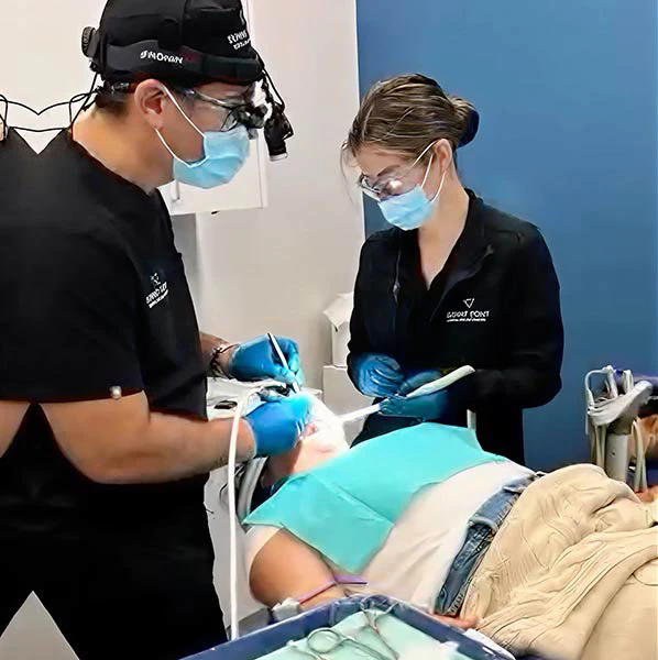 Dr. Khodabakhsh and staff performing dental surgery