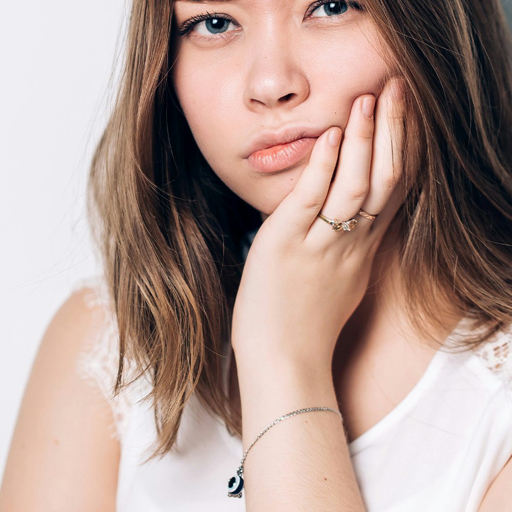 Woman holding jaw in pain
