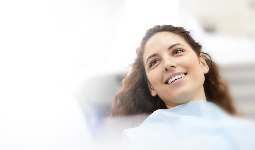 Woman smiling sitting in dental chair