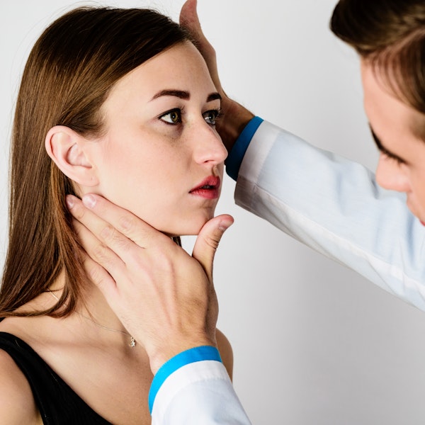 Doctor examining patient's jaw
