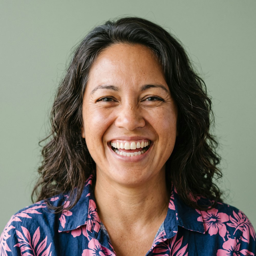 smiling woman in hawaiian shirt