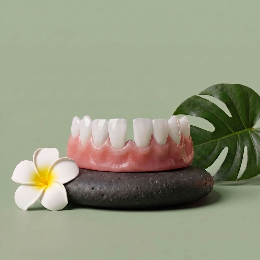 model jaw against sage green background showing gapped teeth