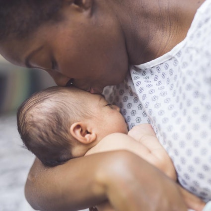 Mother kissing baby's forehead