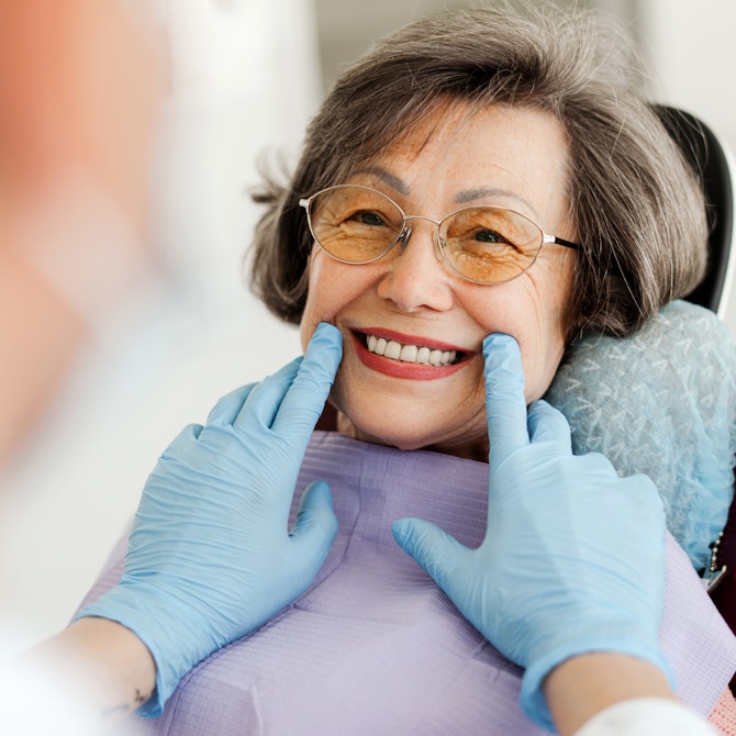 Mature woman smiling in a dental chair