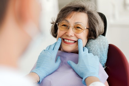 Mature woman smiling in a dental chair