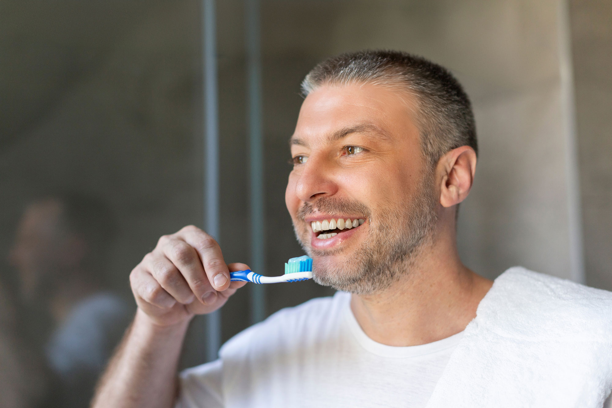man brushing his teeth
