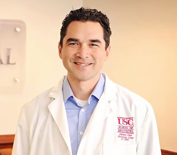 Dr. Latteier wearing a lab coat and smiling