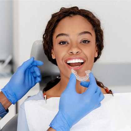 Dentist placing a tray in a patient's mouth