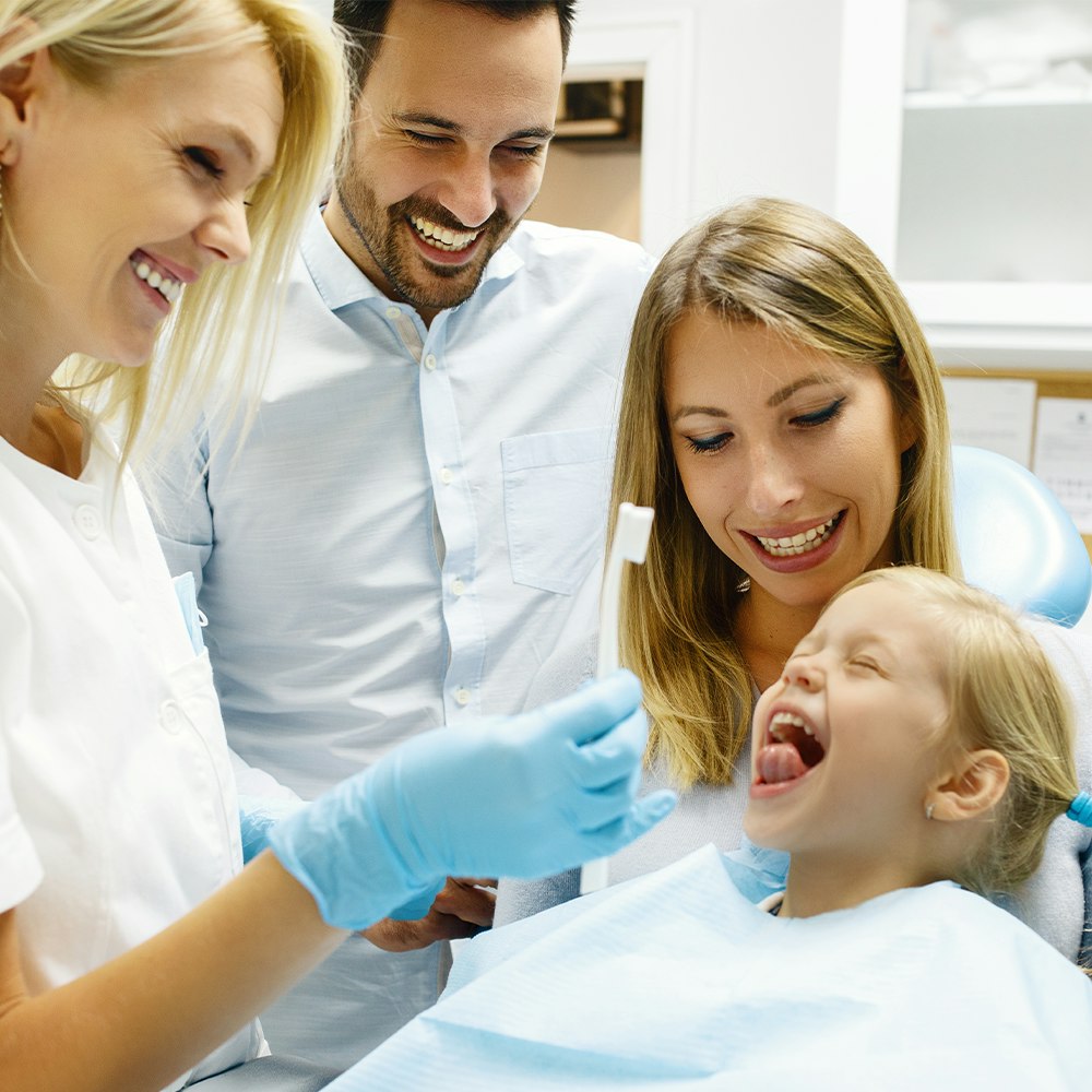 young girl and her mother at a dental appointment