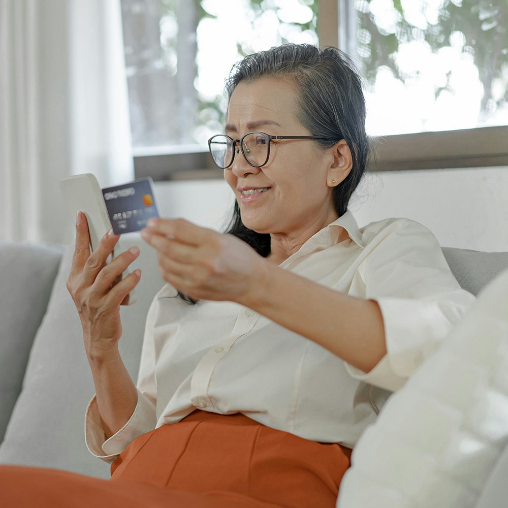 Older woman paying online with a credit card