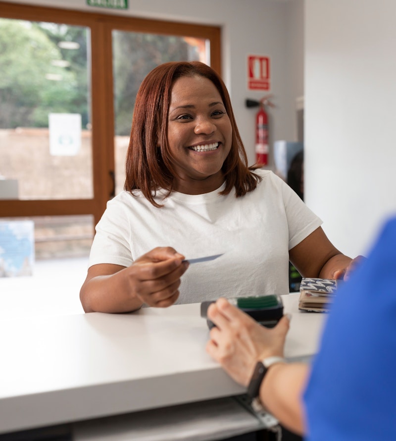 a woman paying the dentist