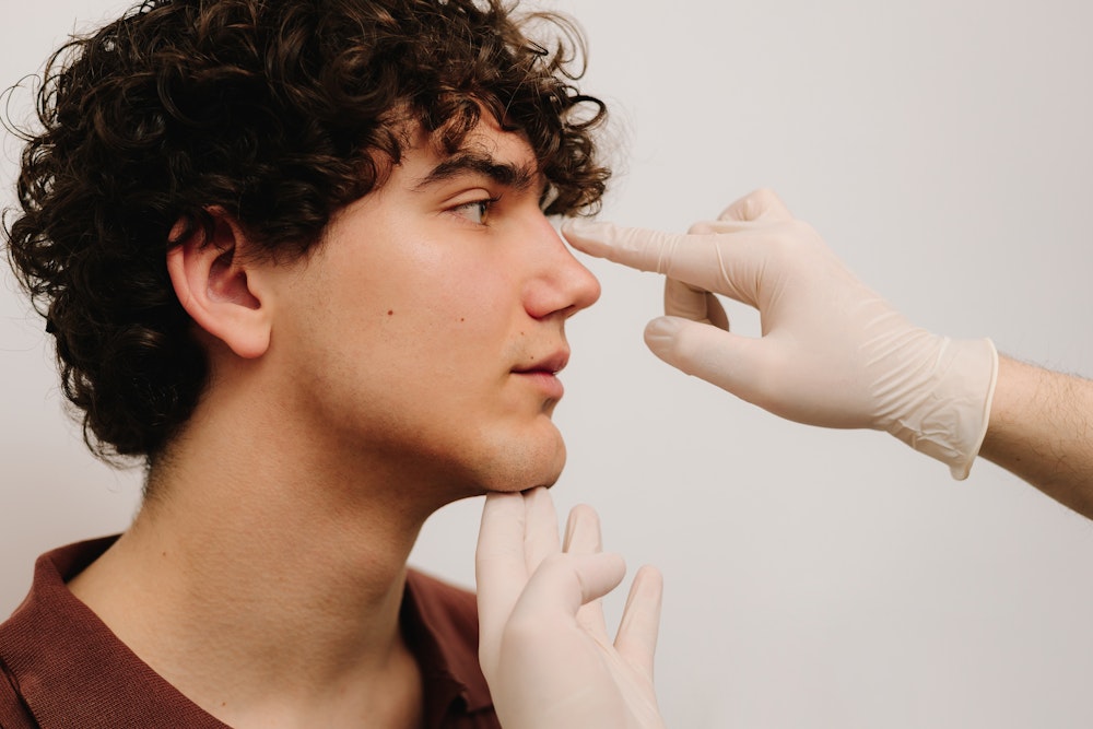 Young man during a rhinoplasty consultation