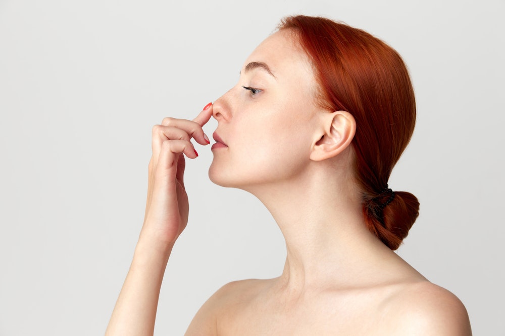 Woman pushing on her nose