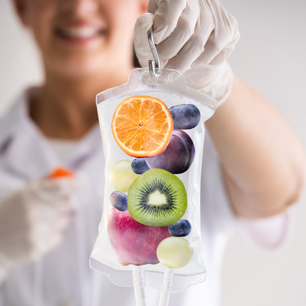 Woman holding saline bag full of high-dose intravenous vitamin C (HDIVC)
