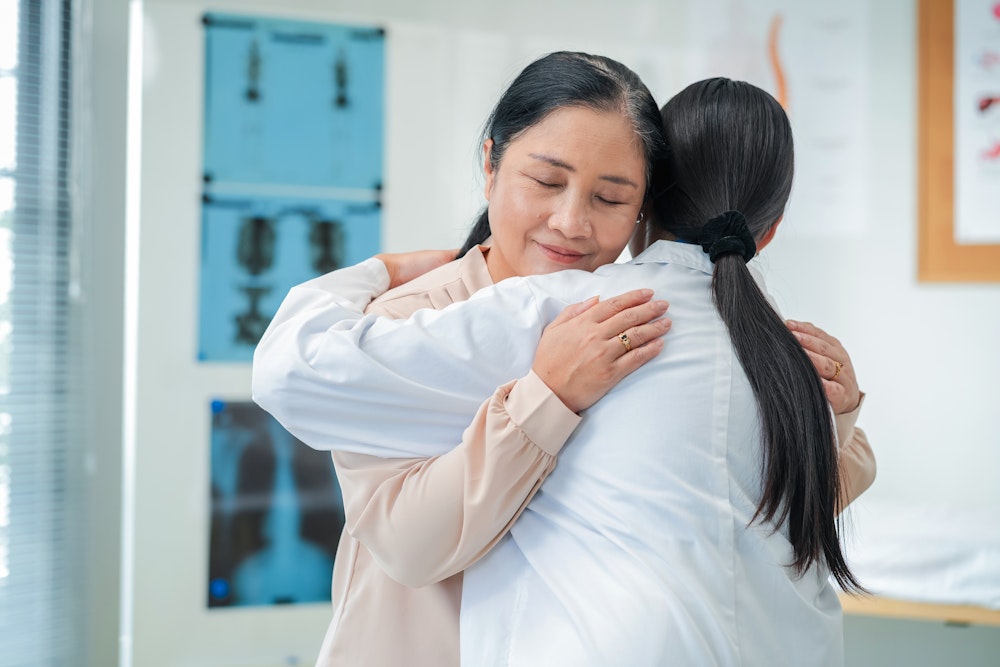 Doctor comforting woman