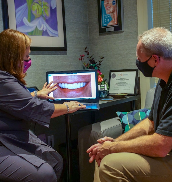 Dr. Lerch and patient going over his new smile