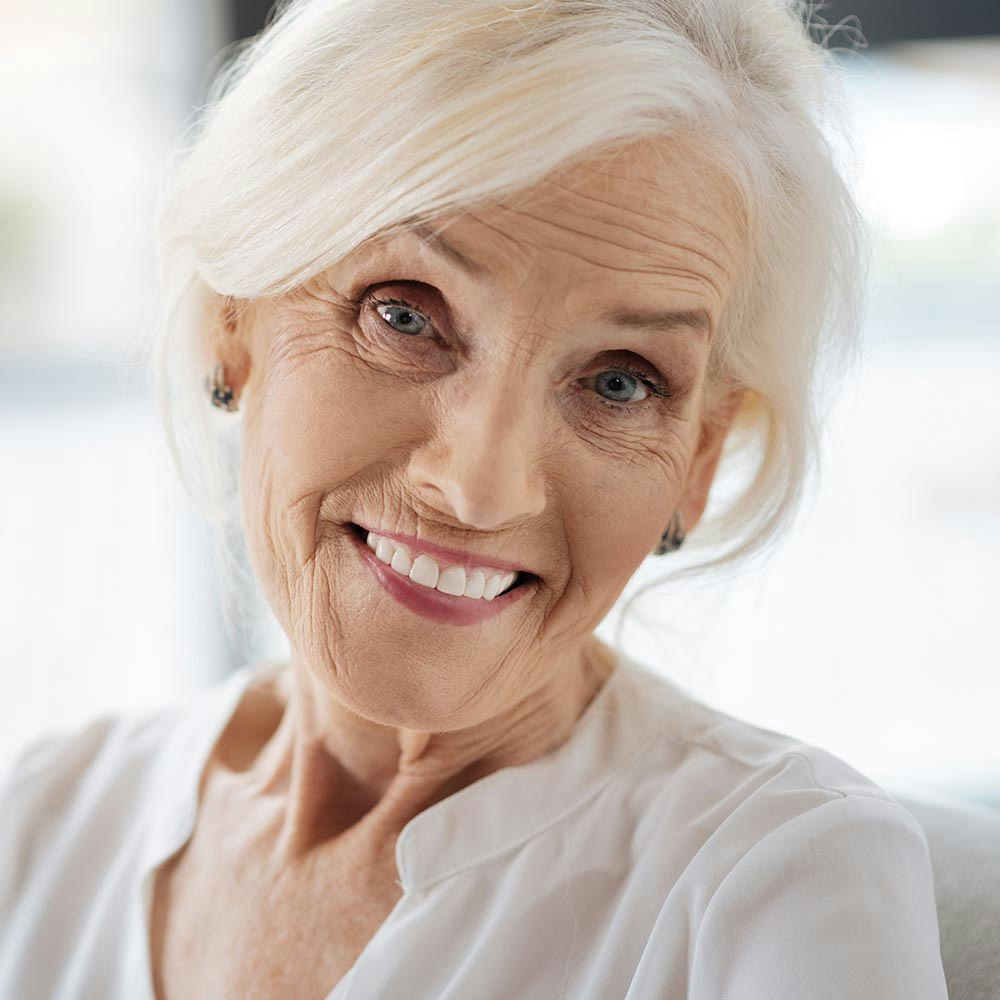Mature woman smiling with dental implants