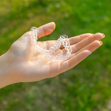 Person holding Invisalign