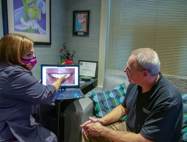 Dr. Lerch educating a dental patient