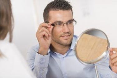 Man trying on glasses