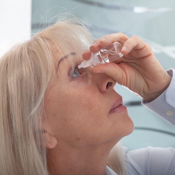woman using eye drops