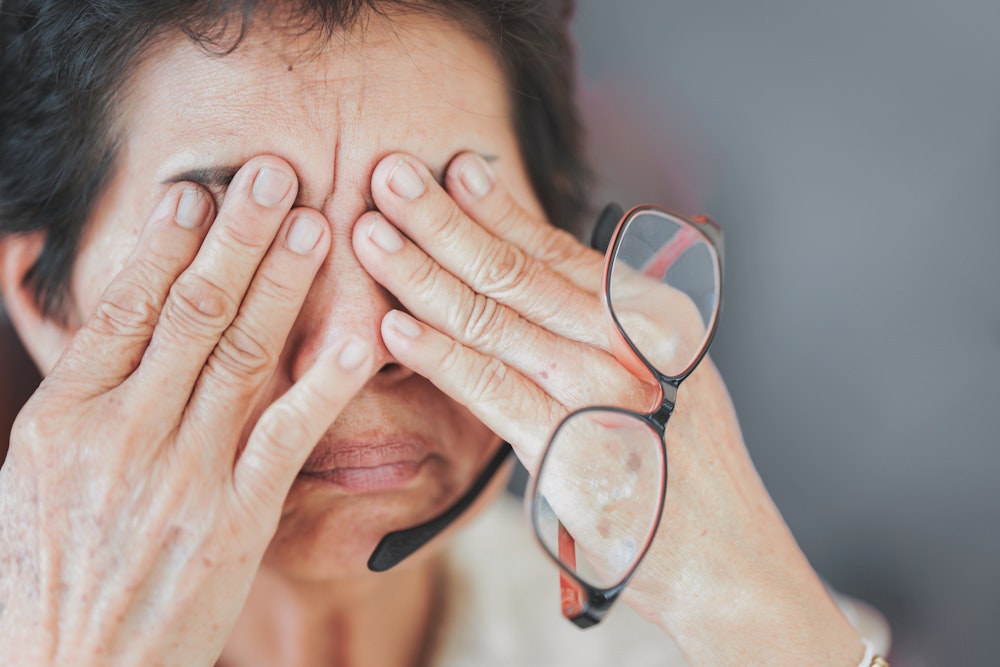 Older woman rubbing her irritated eyes