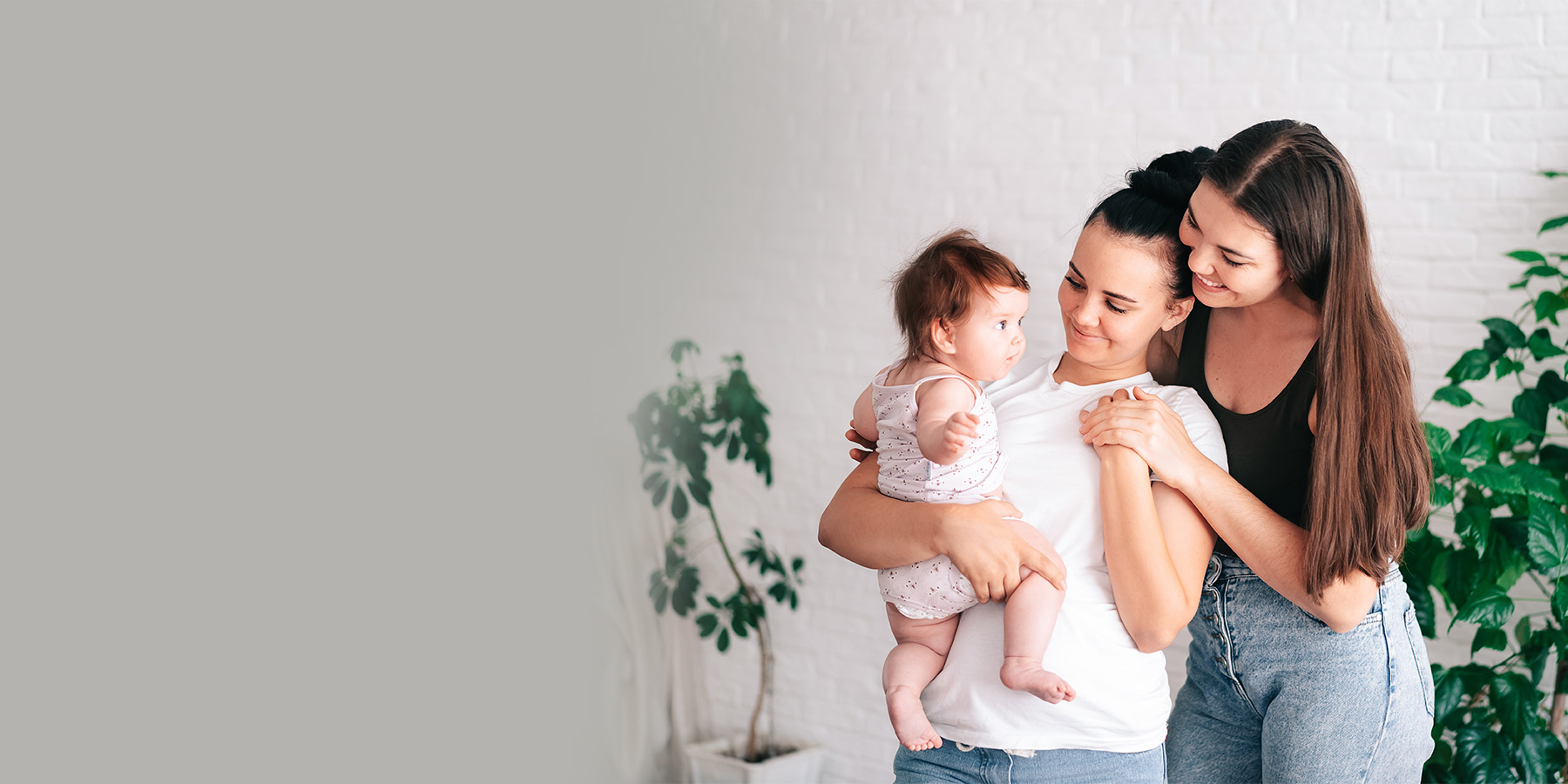 LGBT couple holding their child