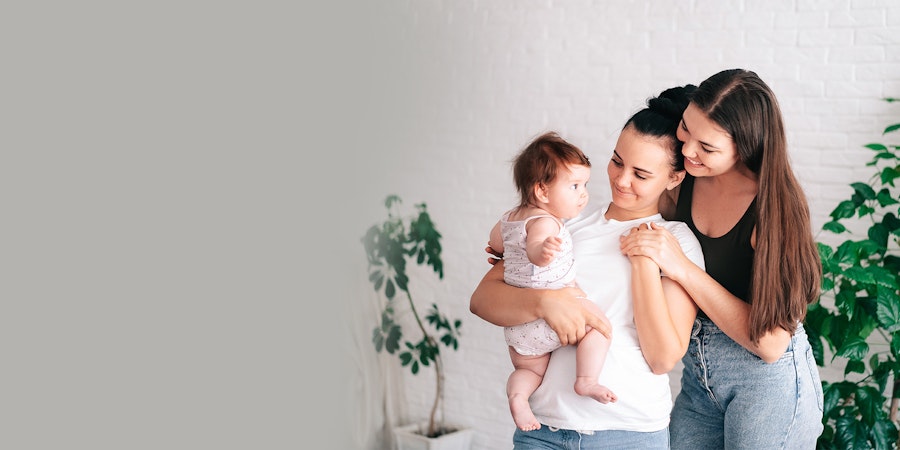 LGBT couple holding their child