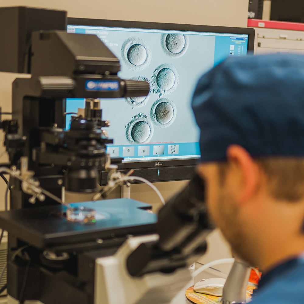 doctor looking through a microscope