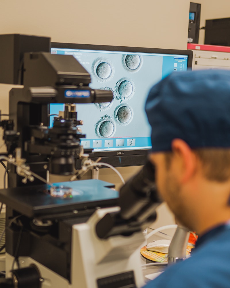doctor looking through a microscope