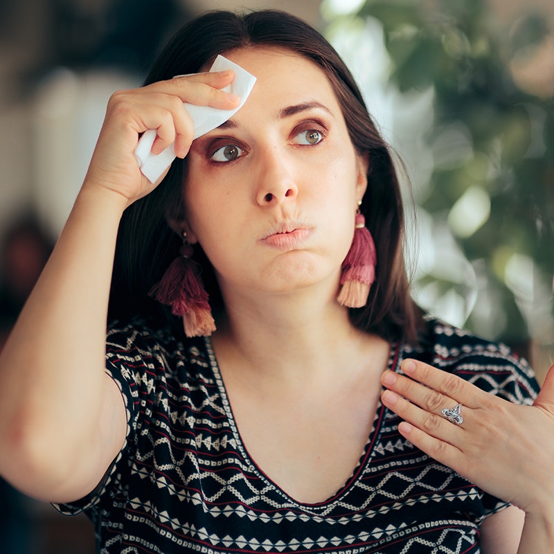 a young woman having hot flashes