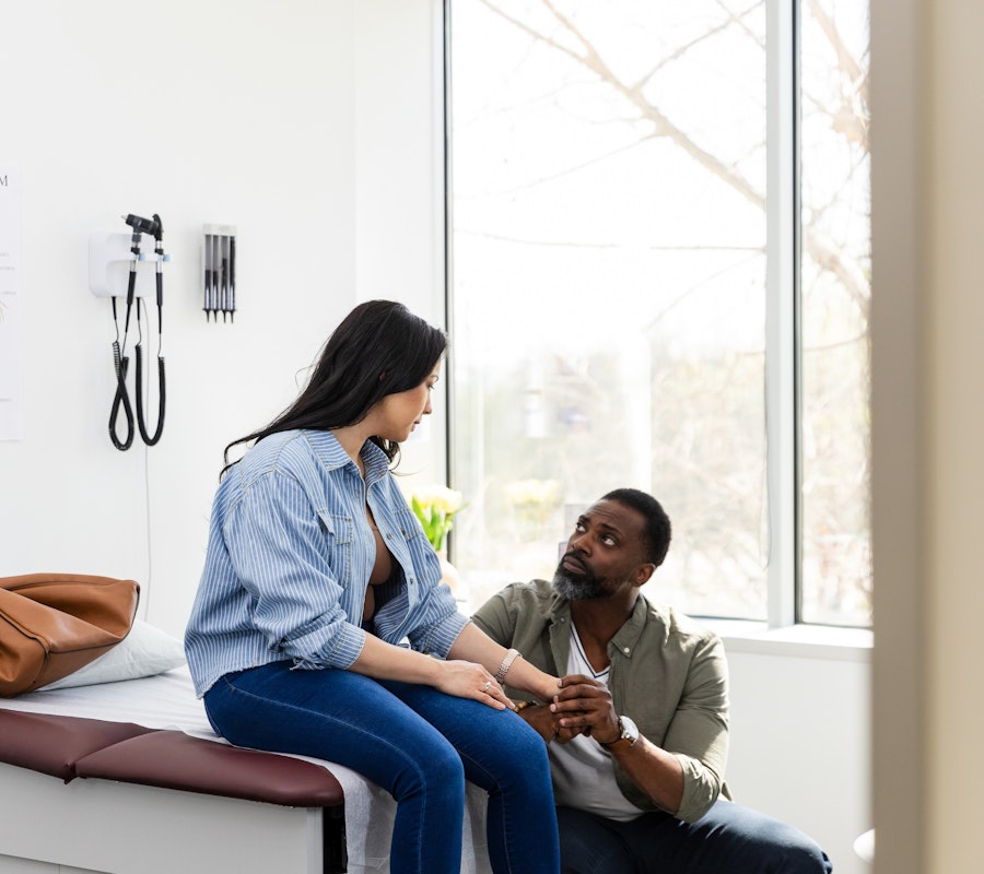 Concerned looking man and woman discussing embryo donation