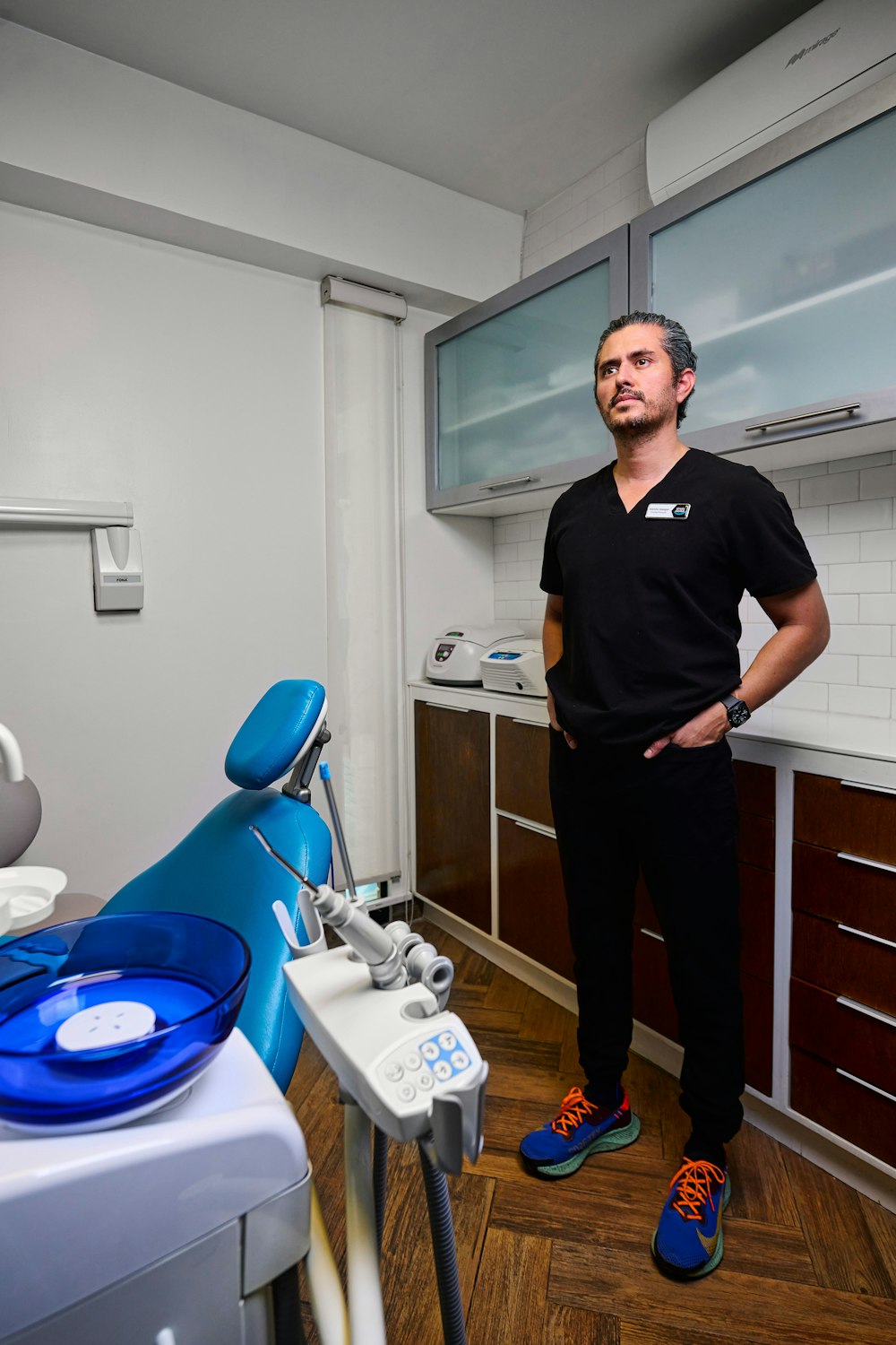 Dr. Gaspar standing next to the dental chair