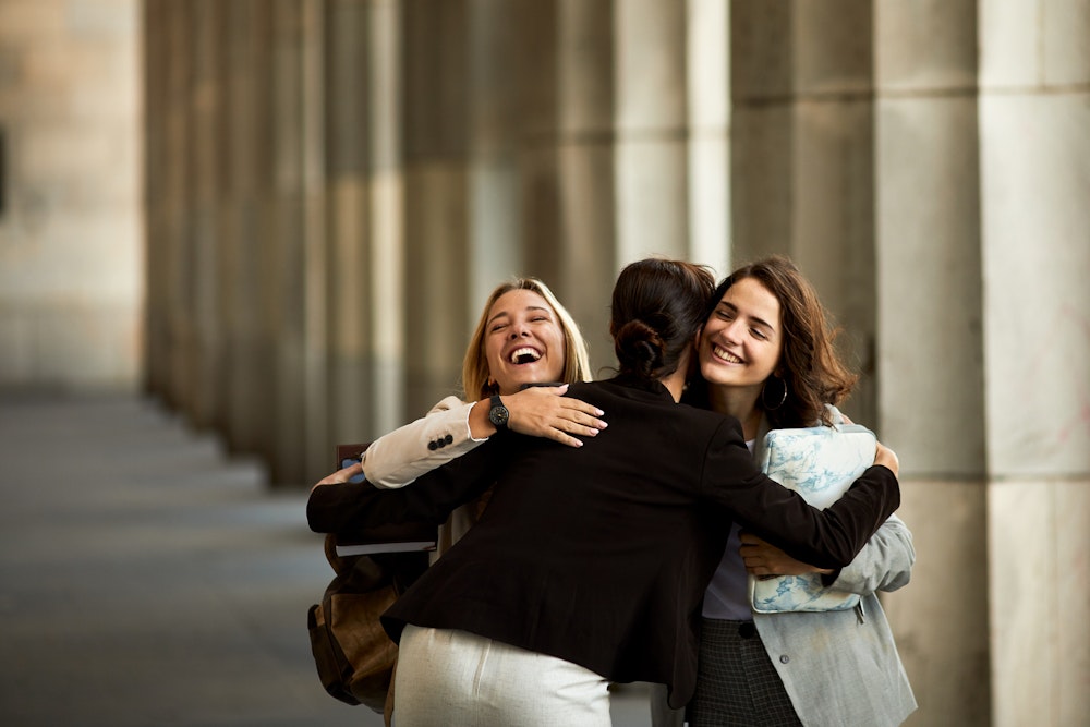 Lawyer hugging clients outside of court