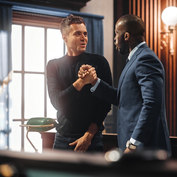Lawyer shaking hands with client in a courthouse