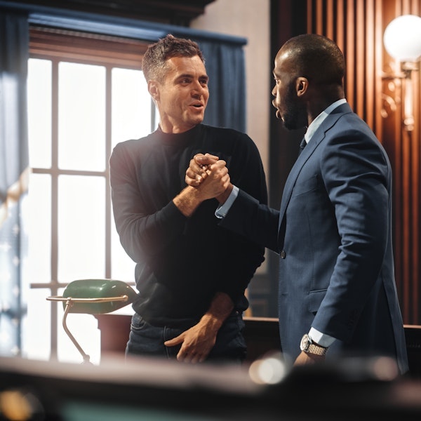 Lawyer shaking hands with client in a courthouse