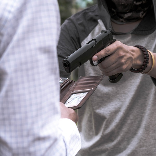 someone robbing a person with a gun